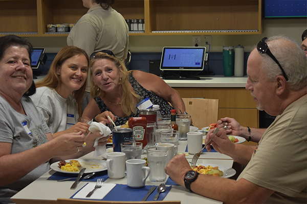 Bus Driver Appreciation 11 Three women smiling for a photo while sitting at a table and eating.