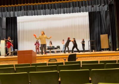 Image of students on stage performing in a auditorium